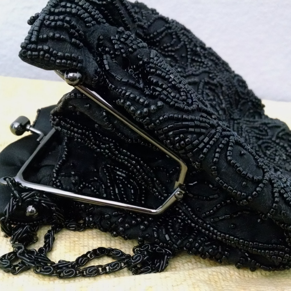 small beaded wristlet with shoulder strap.